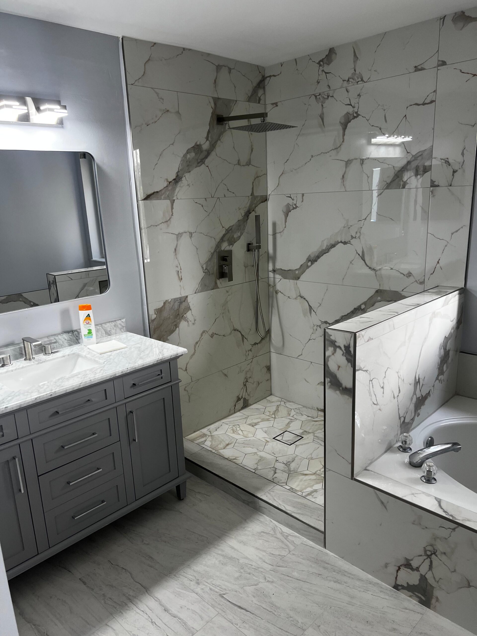Modern bathroom renovation in Hollywood Florida with walk-in shower and stone tile
